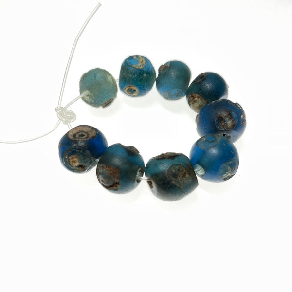 Short Strand of 10 Small Ancient Islamic Glass Evil Eye Beads from