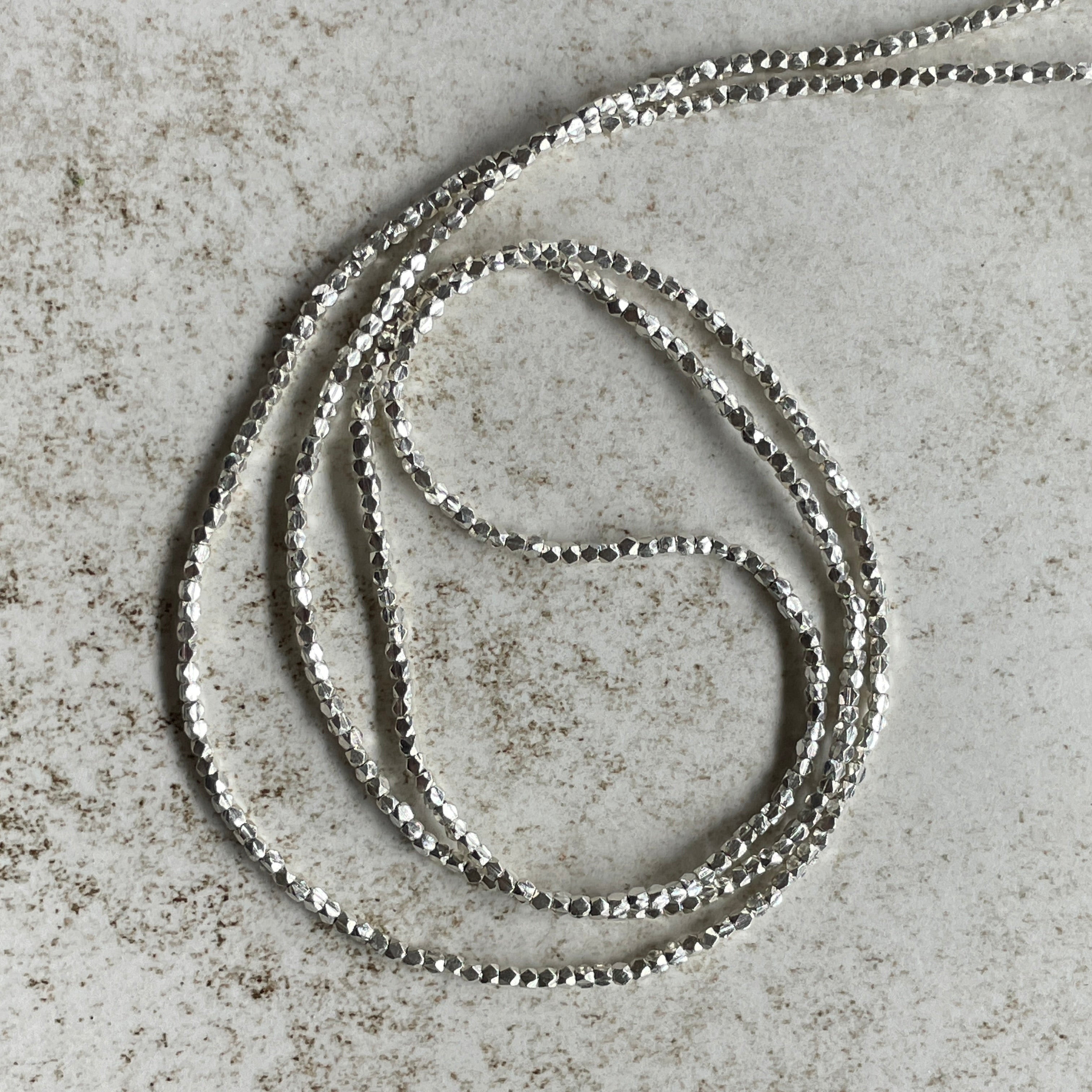 Long Strands of Tiny Faceted Sterling Silver Beads from the