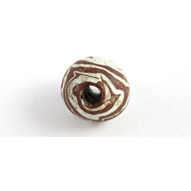 Early Islamic Red Glass Bead with White Trails, Middle East