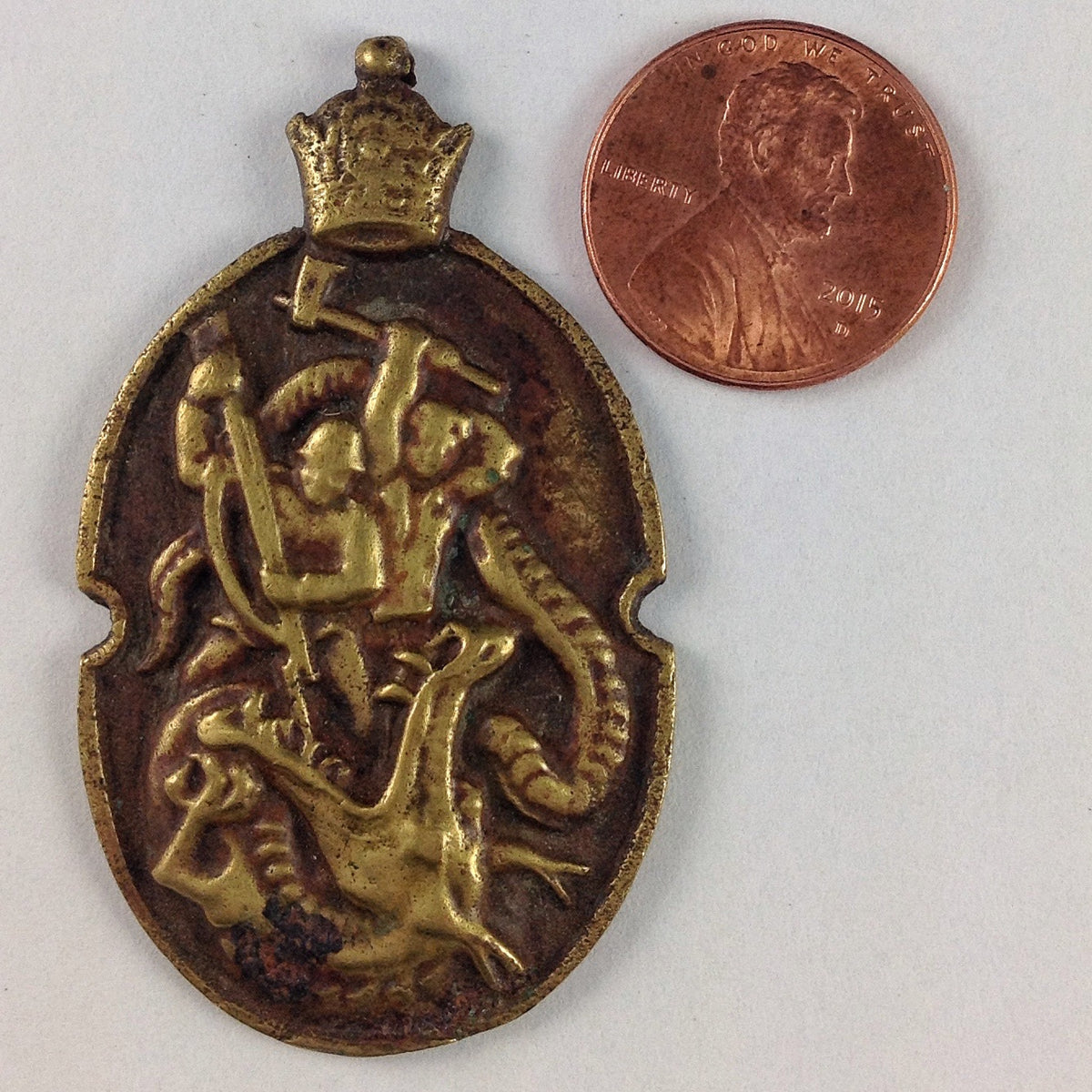 Oval Brass Pendant Depicting Soldiers Battling Evil in Form of Monster - P517